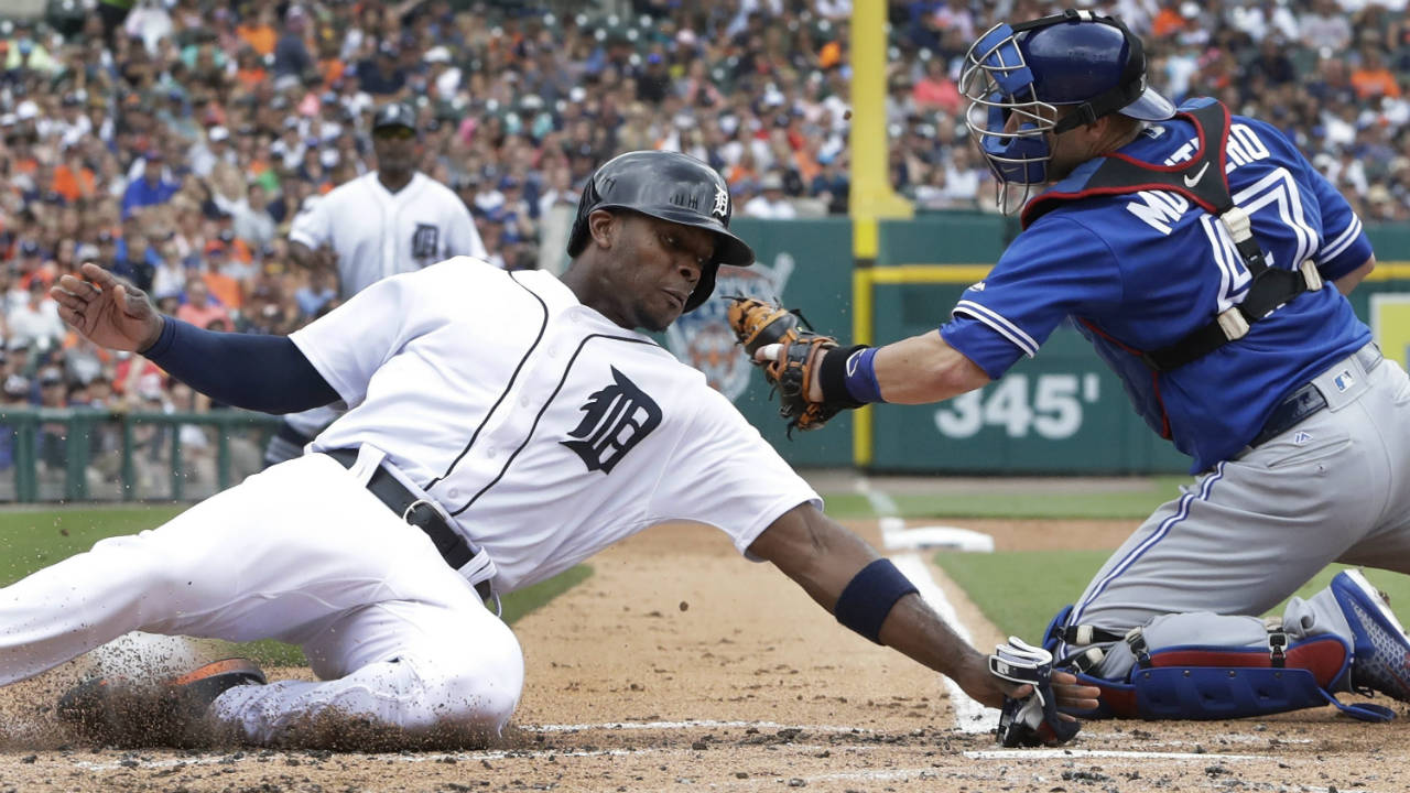 Detroit-Tigers'-Justin-Upton-beats-the-tag-of-Toronto-Blue-Jays-catcher-Miguel-Montero-during-the-first-inning-of-a-baseball-game,-Sunday,-July-16,-2017,-in-Detroit.-Upton-scored-from-third-on-a-sacrifice-fly-hit-by-J.D.-Martinez.-(Carlos-Osorio/AP)