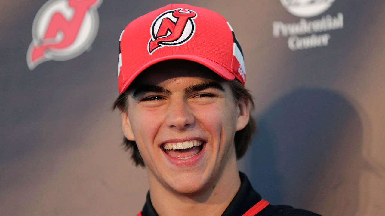 New-Jersey-Devils'-Nico-Hischier-laughs-during-a-news-conference-in-Newark,-N.J.-(Seth-Wenig/AP)