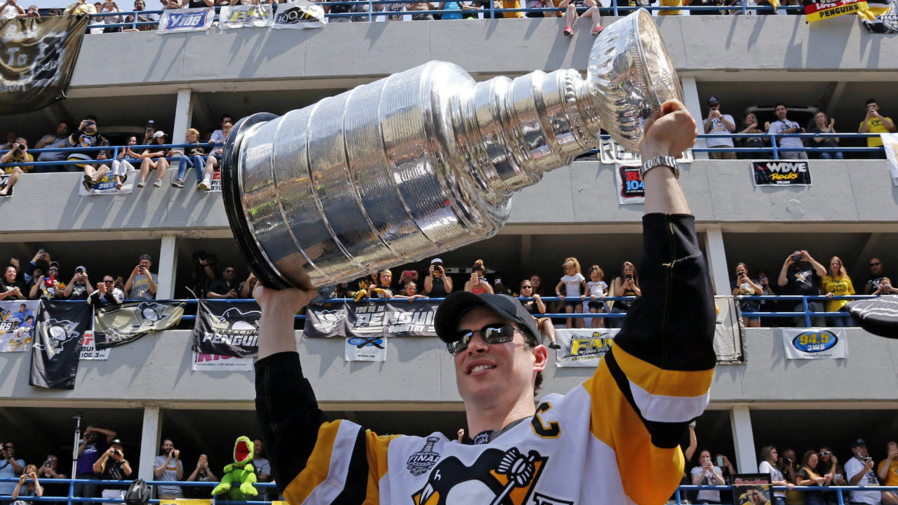 Pittsburgh-Penguins'-Sidney-Crosby-hoists-the-Stanley-Cup-during-the-team's-Stanley-Cup-NHL-hockey-victory-parade-on-Wednesday,-June-14,-2017,-in-Pittsburgh.-(Gene-J.-Puskar/AP)