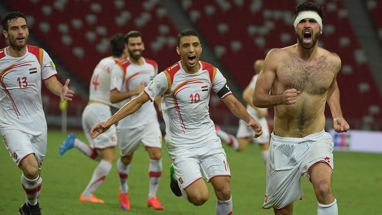 Omar-Khribin-of-Syria,-right,-celebrates-his-game-winning-goal-against-Singapore.-(Joseph-Nair/AP)