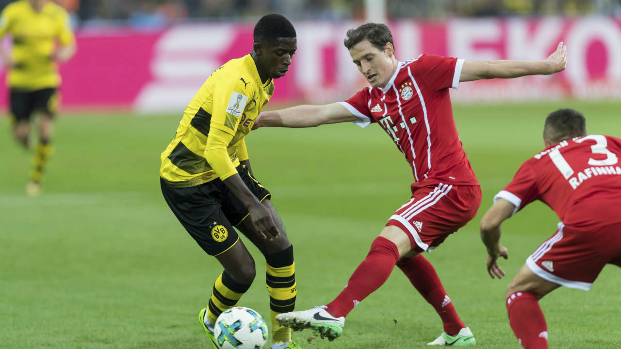 Dortmund's-Ousmane-Dembele,-left,-and-Bayern's-Sebastian-Rudy-vie-for-the-ball-during-the-Supercup-soccer-final-between-FC-Bayern-Munich-and-Borussia-Dortmund-in-the-Signal-Iduna-Park-in-Dortmund,-Germany,-Saturday,-Aug.-5-2017.-(Marius-Becker/dpa-via-AP)