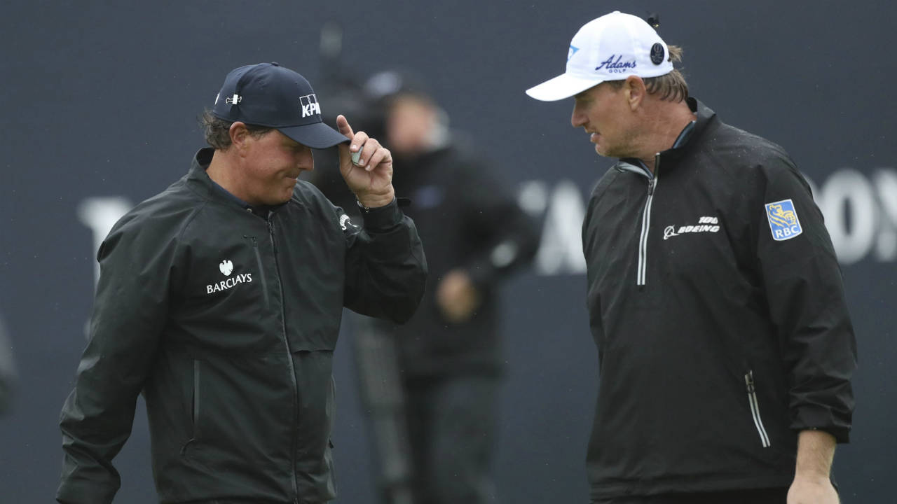 In-this-Friday,-July-15,-2016,-file-photo,-Phil-Mickelson-of-the-United-States,-left,-talks-with-Ernie-Els-of-South-Africa-on-the-18th-green-after-he-completes-his-second-round-of-the-British-Open-Golf-Championship-at-the-Royal-Troon-Golf-Club-in-Troon,-Scotland.-Mickelson-and-Els,-who-first-faced-each-other-in-the-1984-Junior-World-Championship,-are-both-playing-their-100th-major-at-the-PGA-Championship.-(Peter-Morrison,-File/AP)