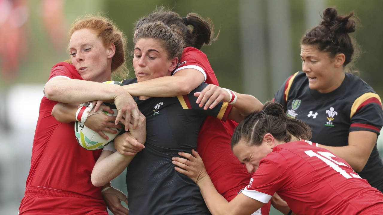 Wales'-Jess-Kavanagh-Williams,-centre,-is-tackled-by-Canada's-Alex-Tessier-during-the-2017-Women's-Rugby-World-Cup,-Pool-A-match-at-UCD-Billings-Park,-Dublin,-Ireland,-Sunday-Aug.-13,-2017.-(Niall-Carson/PA-via-AP)