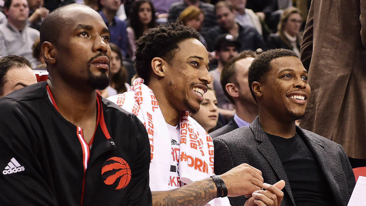 Toronto-Raptors'-Serge-Ibaka,-left-to-right,-DeMar-DeRozan-and-Kyle-Lowry-watch-from-the-bench-as-their-team-takes-on-the-Indiana-Pacers-during-second-half-NBA-basketball-action,-in-Toronto-on-Sunday,-March-19,-2017.-(Frank-Gunn/CP)