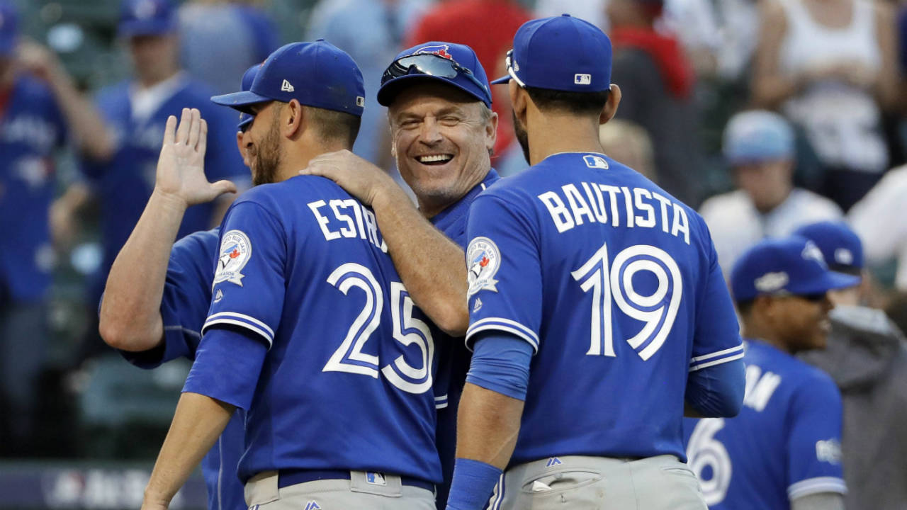 Toronto-Blue-Jays'-Marco-Estrada-(25),-manager-John-Gibbons,-center,-and-Jose-Bautista-(19)-celebrate-the-team's-10-1-win-over-the-Texas-Rangers-in-Game-1-of-baseball's-American-League-Division-Series,-Thursday,-Oct.-6,-2016,-in-Arlington,-Texas.-(David-J.-Phillip/AP)