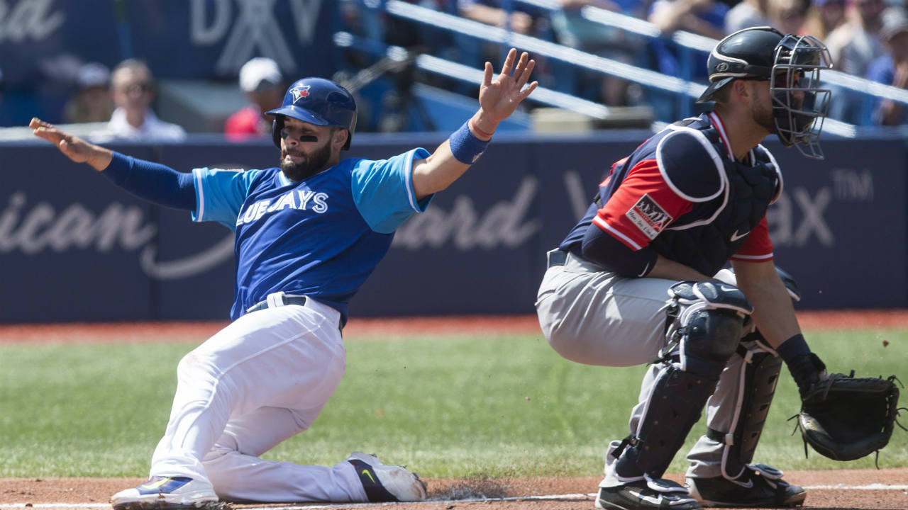 Toronto-Blue-Jays'-Raffy-Lopez,-left,-scores-on-a-sacrifice-fly-in-front-of-Minnesota-Twins-catcher-Mitch-Garver-during-third-inning-American-League-MLB-baseball-action-in-Toronto-on-Saturday,-August-26,-2017.-(Chris-Young/CP)