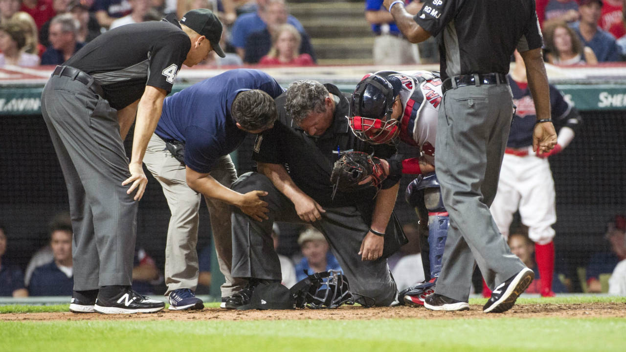 Home-plate-umpire-Hunter-Wendelstedt,-centre-is-attended-to-by-a-Cleveland-Indians-trainer-as-Indians'-catcher-Roberto-Perez-and-umpire-Andy-Fletcher,-left-and-Alan-Porter,-right,-watch-during-the-sixth-inning-of-a-baseball-game-against-the-Boston-Red-Sox-in-Cleveland,-Monday-Aug.-21,-2017.-Wendelstedt-finished-the-inning-but-left-the-game.-(Phil-Long/AP)