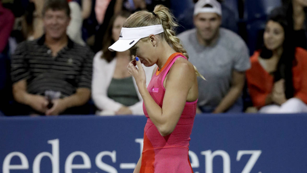 Caroline-Wozniacki,-of-Denmark,-reacts-after-losing-a-point-to-Ekaterina-Makarova,-of-Russia,-at-the-U.S.-Open-tennis-tournament,-Wednesday,-Aug.-30,-2017,-in-New-York.-(Julio-Cortez/AP)