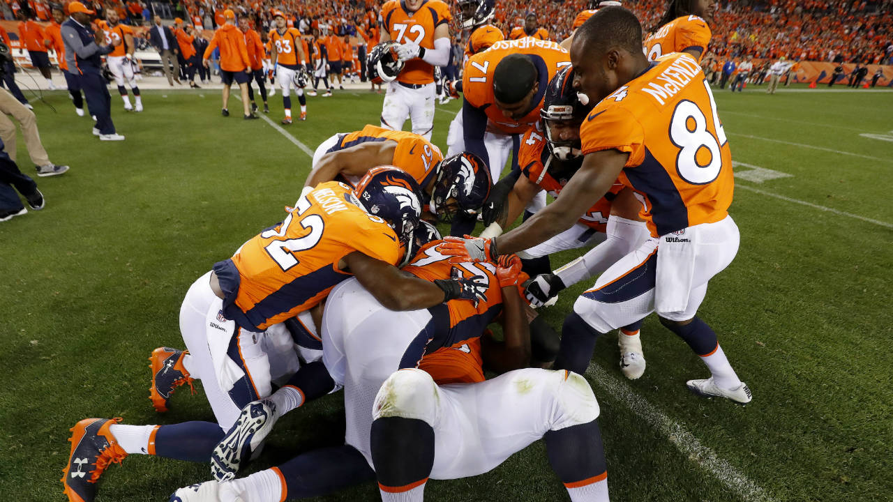 Denver-Broncos-players-tackle-teammate-Shelby-Harris,-bottom-of-pile,-after-an-NFL-football-game,-Monday,-Sept.-11,-2017,-in-Denver.-Harris-tipped-a-game-tying-field-goal-attempt-by-the-Los-Angeles-Chargers-causing-it-to-fall-short.-The-Broncos-won-24-21.-(Jack-Dempsey/AP)