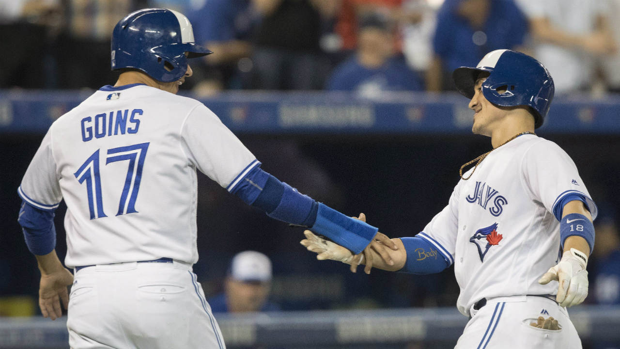 Toronto-Blue-Jays'-Darwin-Barney,-right,-is-congratulated-by-Ryan-Goins-after-driving-him-in-with-a-two-run-home-run-in-the-sixth-inning-of-their-American-League-MLB-baseball-game-against-the-Kansas-City-Royals-in-Toronto-on-Tuesday,-September-19,-2017.-(Fred-Thornhill/CP)