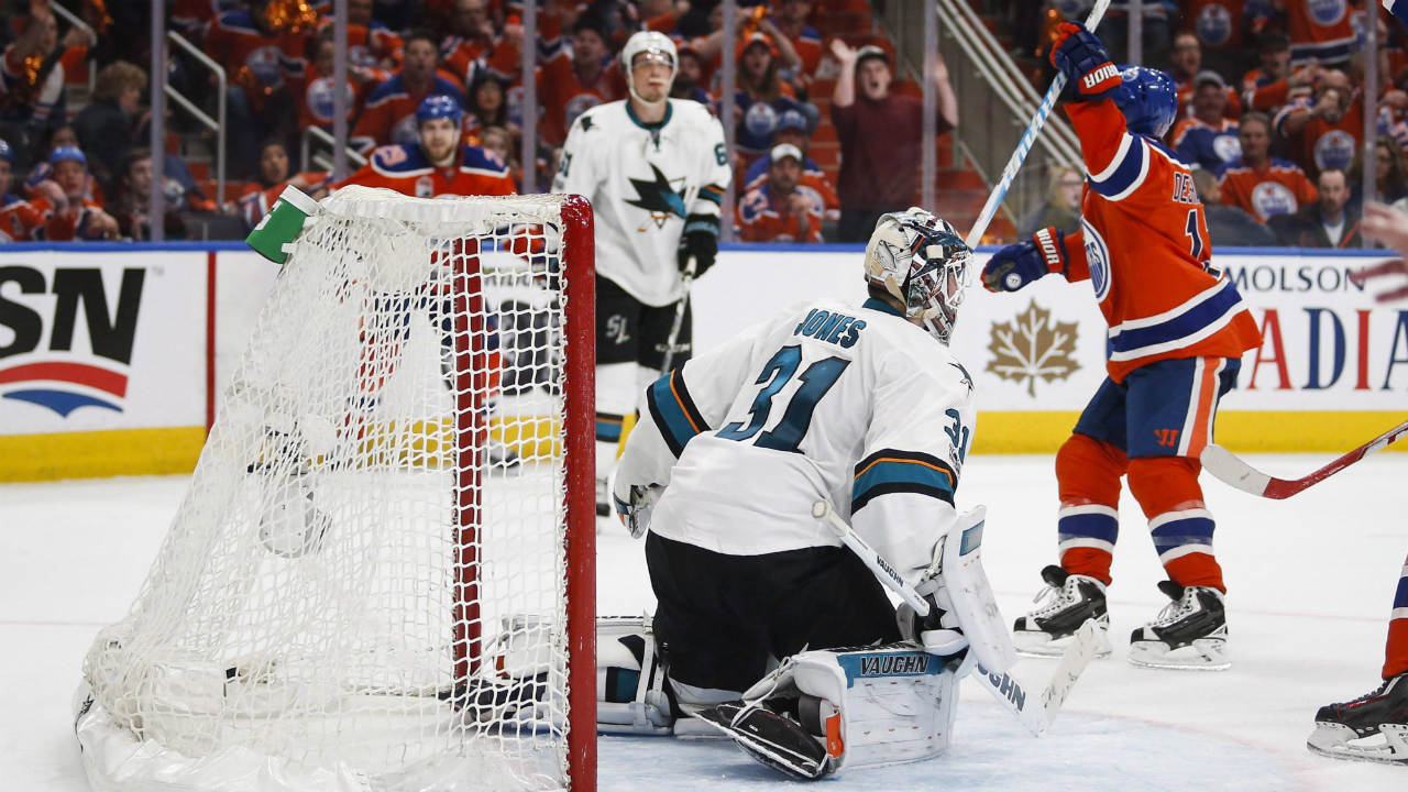 San-Jose-Sharks-goalie-Martin-Jones,-centre,-looks-on-as-Edmonton-Oilers'-David-Desharnais-celebrates-his-game-winning-goal-during-overtime-NHL-hockey-round-one-playoff-action-in-Edmonton,-Thursday,-April-20,-2017.-(Jeff-McIntosh/CP)