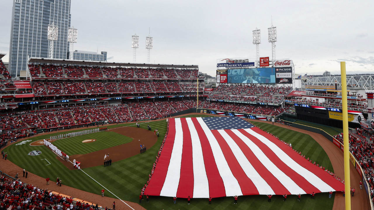 A-giant-flag-is-unfurled-as-fighter-jets-fly-over-Great-American-Ball-Park-as-the-national-anthem-is-played-before-a-baseball-game-between-the-Cincinnati-Reds-and-the-Philadelphia-Phillies,-Monday,-April-3,-2017,-in-Cincinnati.-(John-Minchillo/AP)