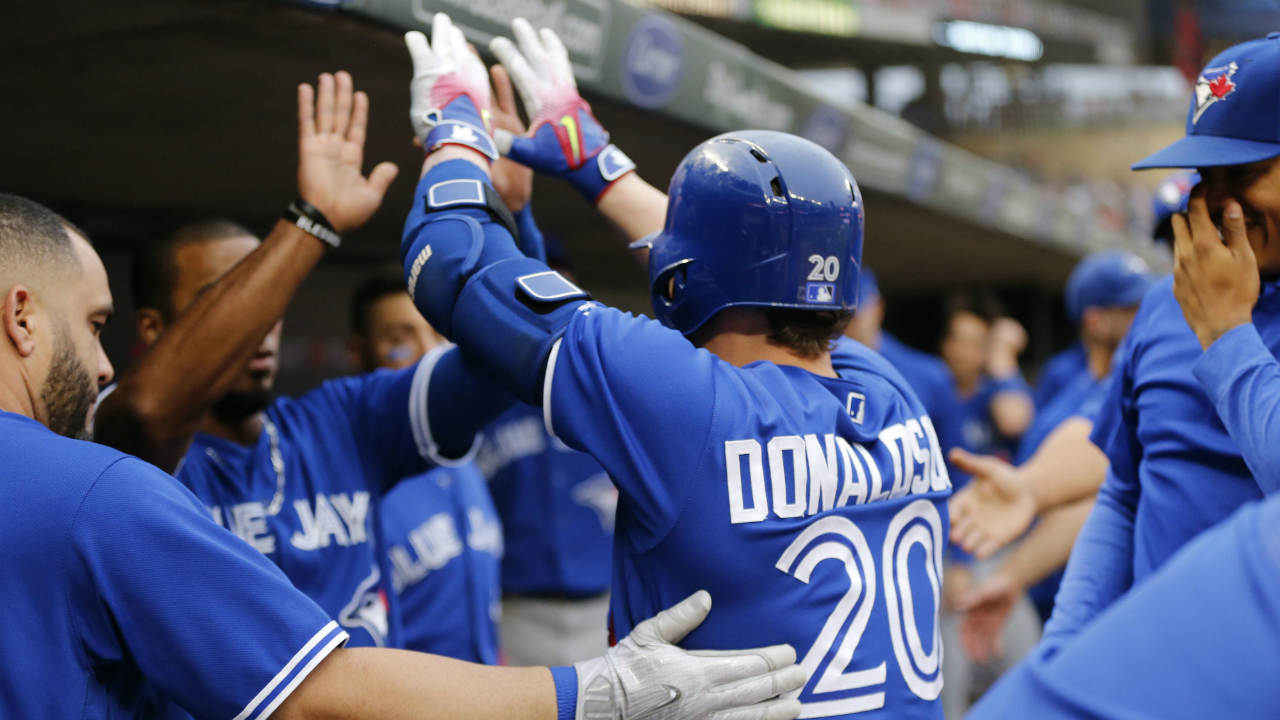 Toronto-Blue-Jays'-Josh-Donaldson-(20)-is-congratulated-in-the-dugout-following-his-solo-home-run-off-Minnesota-Twins-pitcher-Adalberto-Mejia-in-the-first-inning-of-a-baseball-game-Saturday,-Sept.-16,-2017,-in-Minneapolis.-(Jim-Mone/AP)