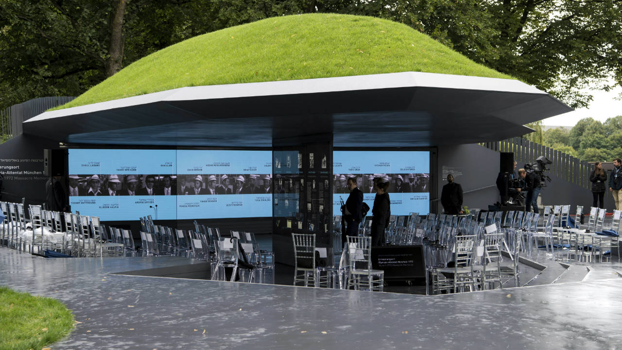 Visitors-look-at-information-displays-at-the-newly-unveiled-memorial-commemorating-the-eleven-Israeli-athletes,-who-were-killed-in-a-terrorist-attack-during-the-1972-Olympic-Games-in-Munich,-Germany,-Wednesday,-Sept.-6,-2017.-(Sven-Hoppe/dpa-via-AP)