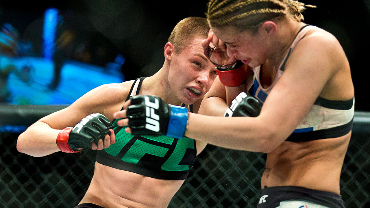 Women’s strawweight fighter Rose Namajunas, left, connects to the head of P...