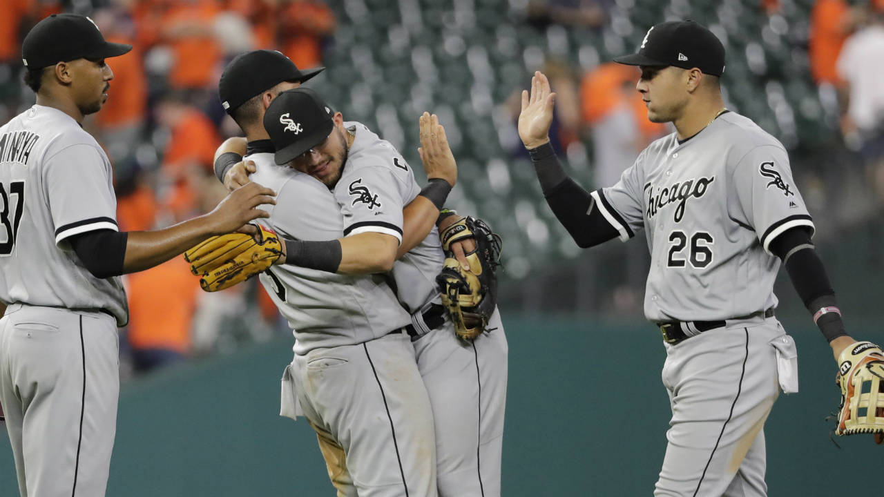 Chicago-White-Sox's-Jose-Abreu,-centre-left,-hugs-Yolmer-Sanchez-as-they-celebrate-with-Avisail-Garcia-(26)-and-Juan-Minaya-(37)-after-a-baseball-game-against-the-Houston-Astros-on-Thursday,-Sept.-21,-2017,-in-Houston.-The-White-Sox-won-3-1.-(David-J.-Phillip/AP)