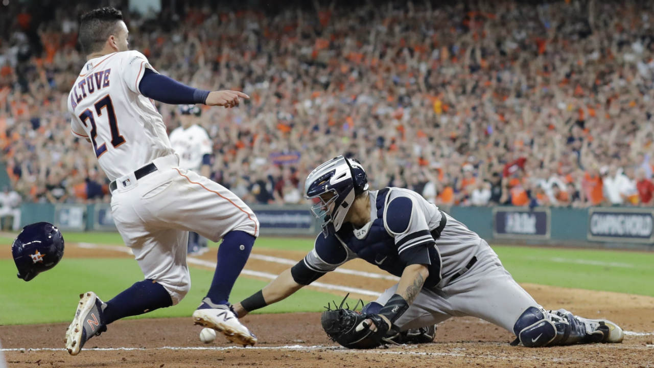 Houston-Astros'-Jose-Altuve-scores-the-game-winning-run-past-New-York-Yankees-catcher-Gary-Sanchez-during-the-ninth-inning-of-Game-2-of-baseball's-American-League-Championship-Series-Saturday,-Oct.-14,-2017,-in-Houston.-The-Astros-won-2-1-to-take-a-2-0-lead-in-the-series.-(David-J.-Phillip/AP)