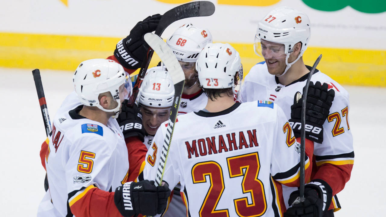 Calgary-Flames'-Mark-Giordano,-from-left-to-right,-Johnny-Gaudreau,-Jaromir-Jagr,-of-the-Czech-Republic,-Sean-Monahan-and-Dougie-Hamilton-celebrate-Monahan's-goal-during-second-period-NHL-hockey-action-against-the-Vancouver-Canucks,-in-Vancouver-on-Saturday,-October-14,-2017.-(Darryl-Dyck/CP)