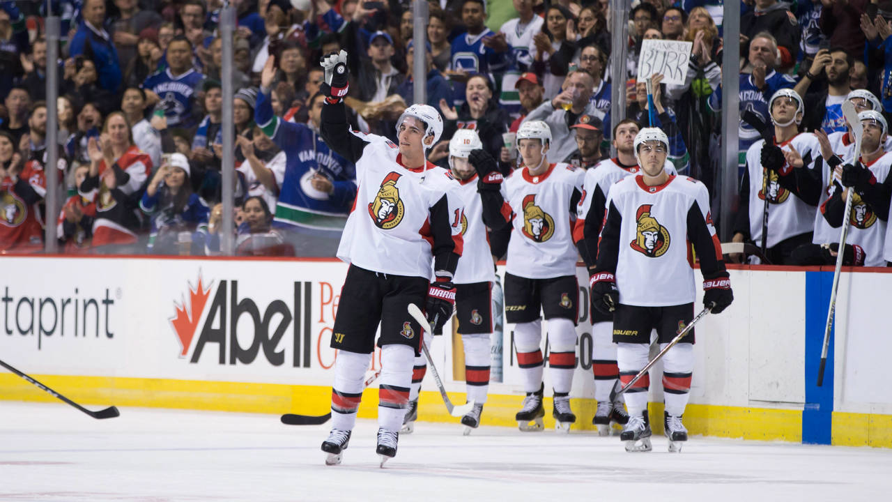 Ottawa-Senators'-Alex-Burrows,-front,-acknowledges-a-standing-ovation-from-the-crowd-after-a-video-tribute-was-played-for-him-by-his-former-team,-the-Vancouver-Canucks,-during-first-period-NHL-hockey-action-in-Vancouver-on-Tuesday,-October-10,-2017.-(Darryl-Dyck/CP)