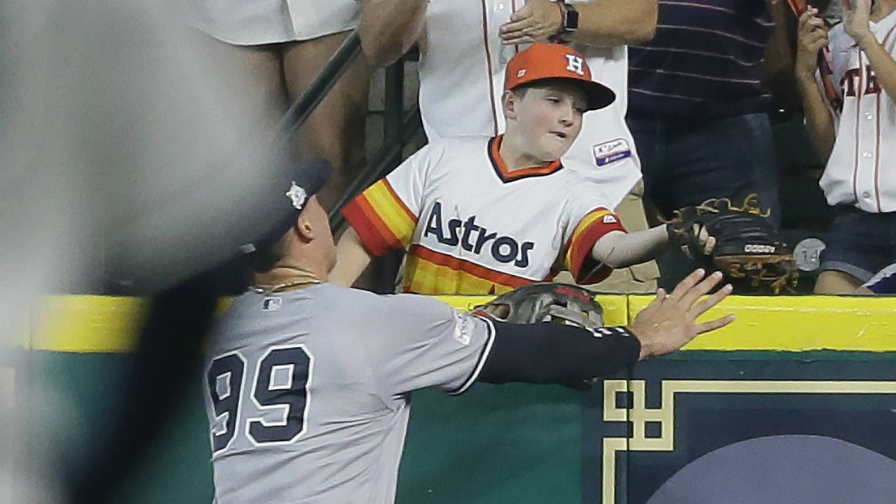 A-young-fan-catches-a-home-run-hit-by-Houston-Astros'-Carlos-Correa-in-front-of-New-York-Yankees'-Aaron-Judge-(99)-during-the-fourth-inning-of-Game-2-of-baseball's-American-League-Championship-Series-Saturday,-Oct.-14,-2017,-in-Houston.-(Tony-Gutierrez/AP)