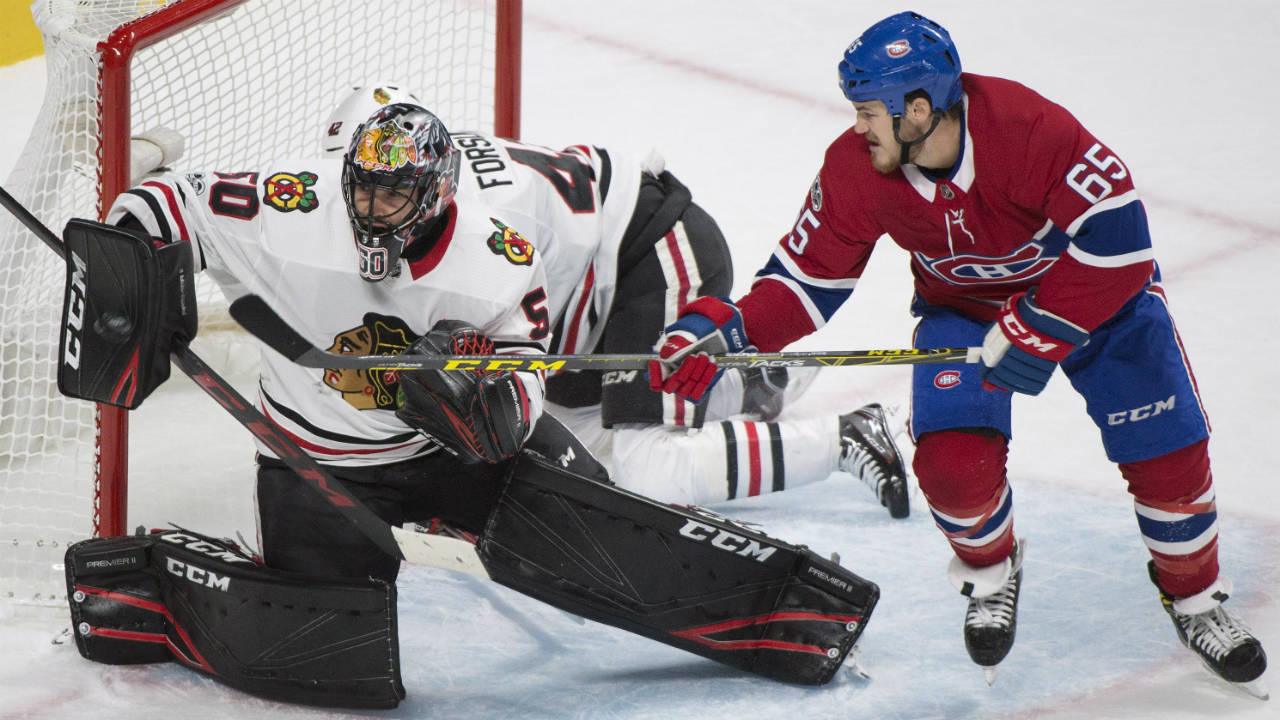 Chicago-Blackhawks-goalie-Corey-Crawford-(50)-makes-a-save-as-Montreal-Canadiens'-Andrew-Shaw-(65)-looks-for-the-rebound-during-first-period-NHL-hockey-action-in-Montreal,-Tuesday,-October-10,-2017.-(Graham-Hughes/CP)