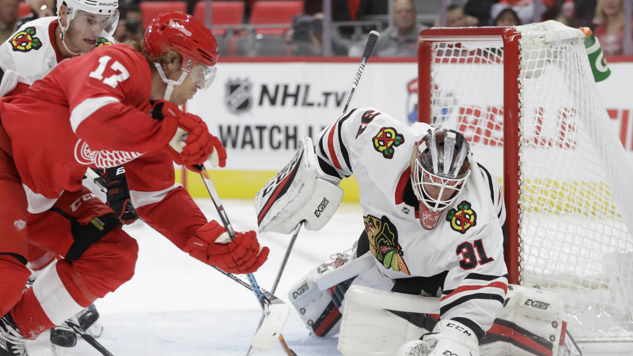 Detroit-Red-Wings-left-wing-David-Booth-(17)-and-Chicago-Blackhawks-goalie-Anton-Forsberg-(31),-of-Sweden,-try-controlling-the-puck-during-the-second-period-of-an-NHL-hockey-game,-Thursday,-Sept.-28,2017,-in-Detroit.-(Carlos-Osorio/AP)