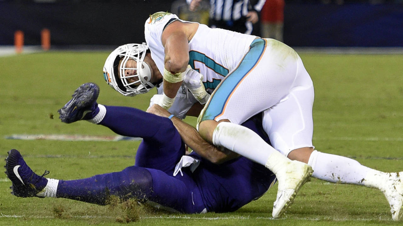 Miami-Dolphins-middle-linebacker-Kiko-Alonso,-top,-collides-with-Baltimore-Ravens-quarterback-Joe-Flacco-as-Flacco-slides-on-the-field-after-rushing-the-ball-in-the-first-half-of-an-NFL-football-game,-Thursday,-Oct.-26,-2017,-in-Baltimore.-(Nick-Wass/AP)