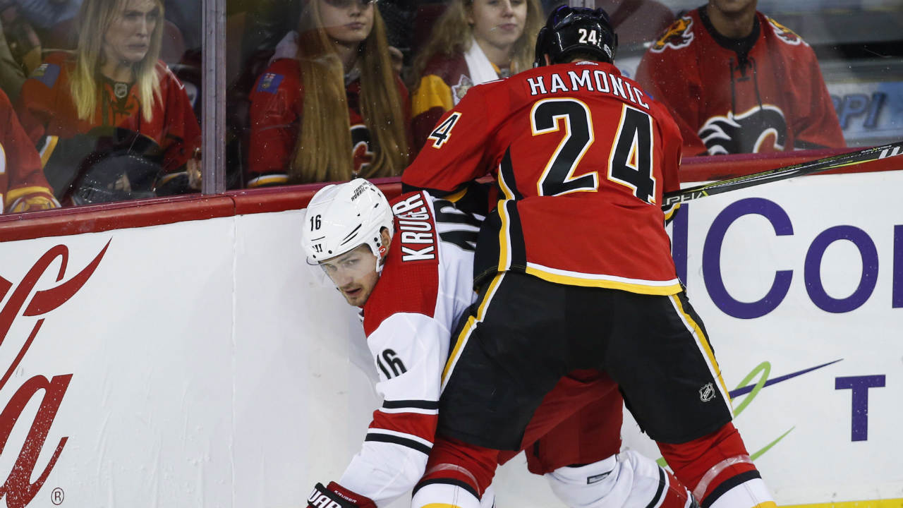 Carolina-Hurricanes'-Marcus-Kruger,-left,-from-Sweden,-is-checked-by-Calgary-Flames'-Travis-Hamonic-during-second-period-NHL-hockey-action-in-Calgary,-Thursday,-Oct.-19,-2017.-(Jeff-McIntosh/CP)