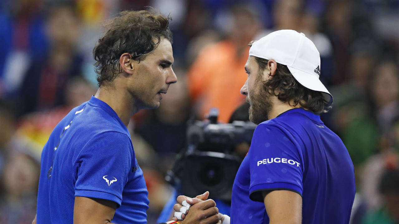 Rafael-Nadal-of-Spain,-left,-shakes-hands-with-Lucas-Pouille-of-France-after-winning-their-men's-singles-match-in-the-China-Open-tennis-tournament-at-the-Diamond-Court-in-Beijing,-Tuesday,-Oct.-3,-2017.-(Andy-Wong/AP)