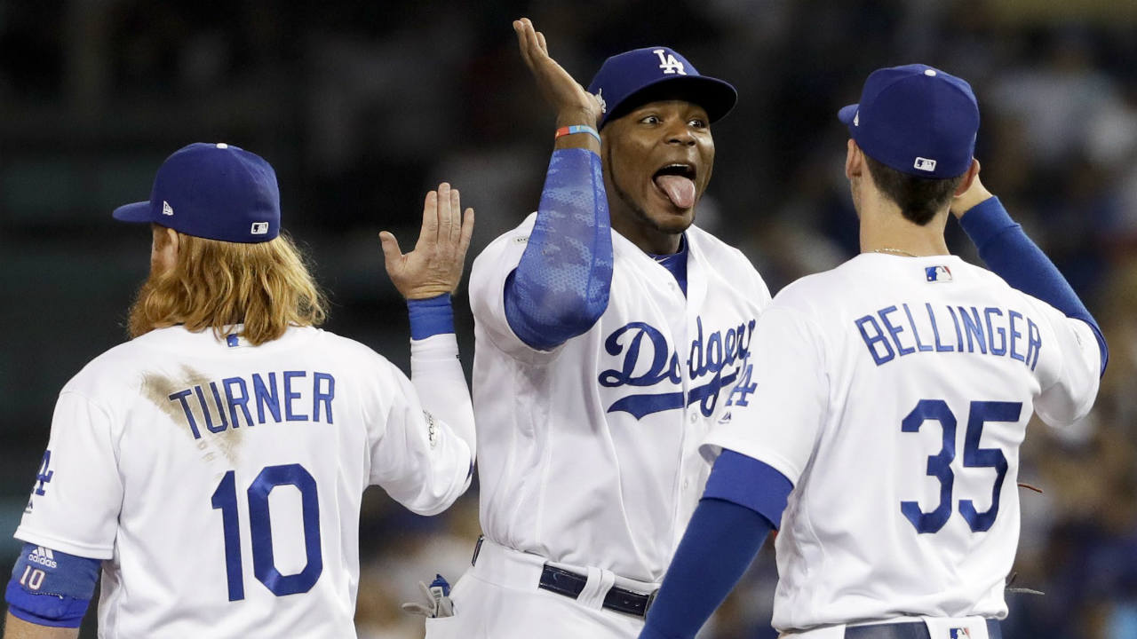 Los-Angeles-Dodgers-right-fielder-Yasiel-Puig,-middle,-celebrates-the-Dodgers'-5-2-win-with-third-baseman-Justin-Turner,-left,-and-first-baseman-Cody-Bellinger-after-Game-1-of-baseball's-National-League-Championship-Series-against-the-Chicago-Cubs-in-Los-Angeles,-Saturday,-Oct.-14,-2017.-(Matt-Slocum/AP)