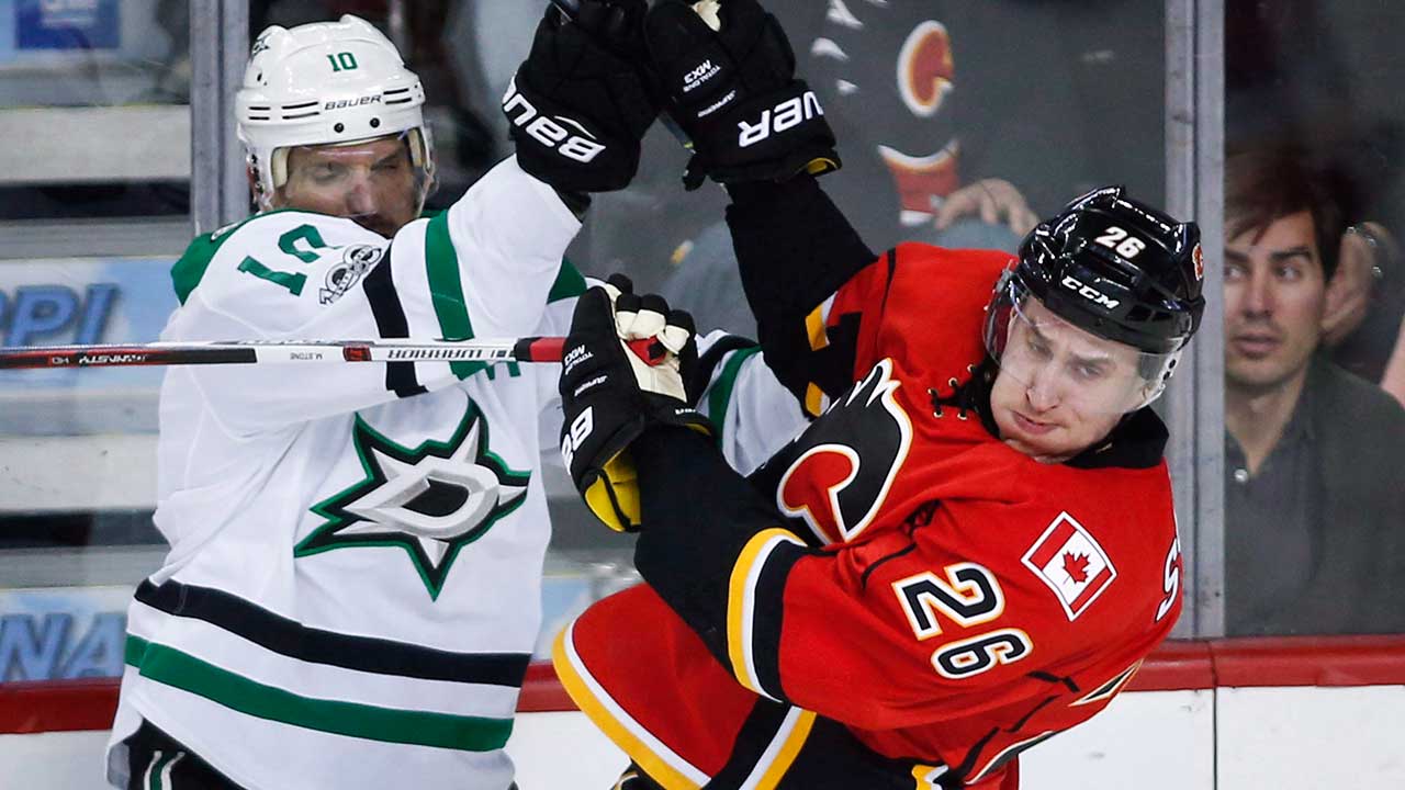 Dallas Stars' Patrick Sharp, left, and Calgary Flames' Michael Stone collide during third period NHL hockey action in Calgary, Friday, March 17, 2017. (Jeff McIntosh/CP)