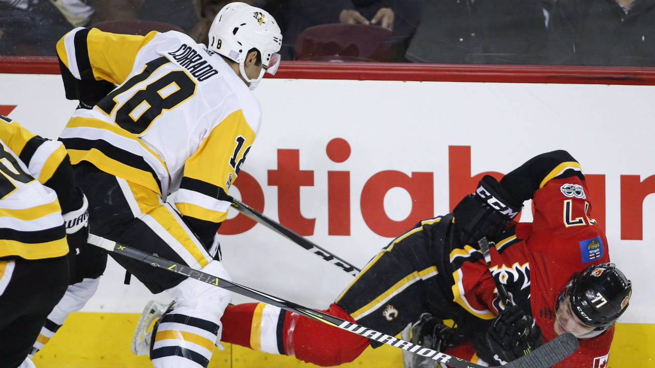 Pittsburgh-Penguins'-Frank-Corrado,-left,-knocks-Calgary-Flames'-Mark-Jankowski-to-the-ice-during-first-period-NHL-hockey-action-in-Calgary,-Thursday,-Nov.-2,-2017.-(Jeff-McIntosh/CP)