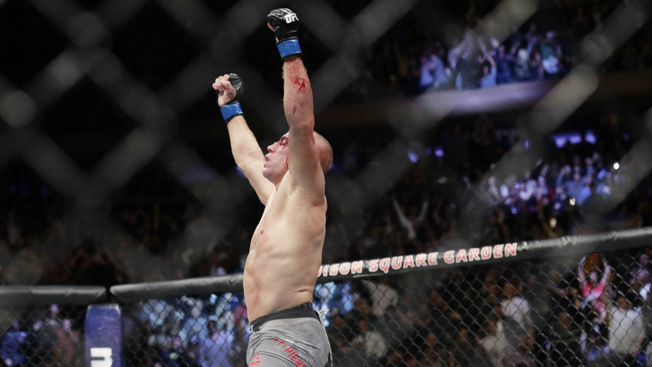 Georges-St-Pierre,-of-Canada,-celebrates-after-winning-a-middleweight-title-mixed-martial-arts-bout-against-England's-Michael-Bisping-at-UFC-217-early-Sunday,-Nov.-5,-2017,-in-New-York.-(Frank-Franklin-II/AP)
