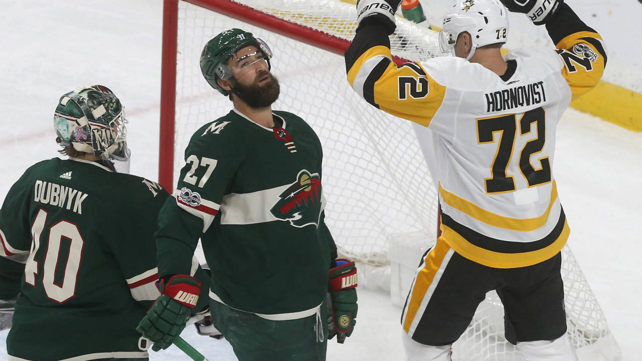 Pittsburgh-Penguins'-Patric-Hornqvist,-right,-of-Sweden,-celebrates-a-power-play-goal-by-Evgeni-Malkin-of-Russia-off-Minnesota-Wild-goalie-Devan-Dubnyk,-left,-during-the-first-period-of-an-NHL-hockey-game-Saturday,-Oct.-28,-2017,-in-St.-Paul,-Minn.-Wild's-Kyle-Quincey-(27)-reacts.-(Jim-Mone/AP)