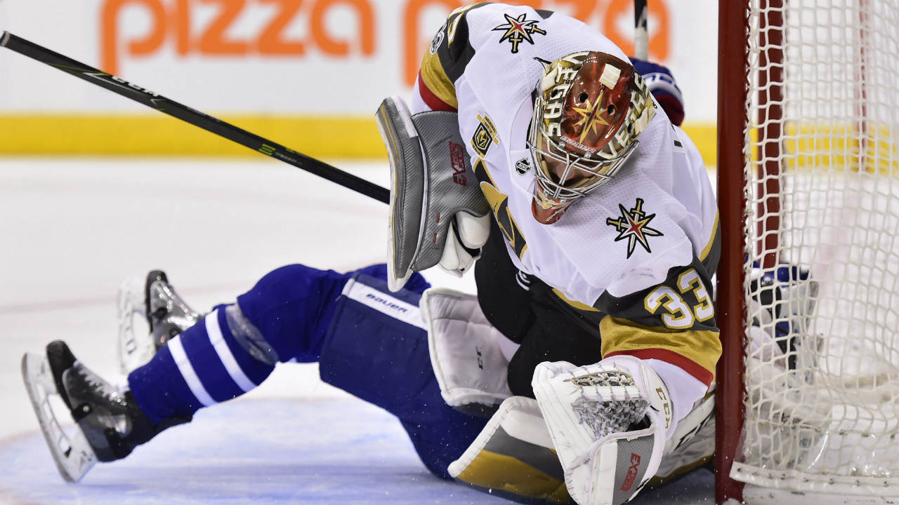 Vegas-Golden-Knights-goalie-Maxime-Lagace-(33)-is-run-over-by-Toronto-Maple-Leafs-centre-Zach-Hyman-(obscured)-during-second-period-NHL-hockey-action-in-Toronto-on-Monday,-Nov.-6,-2017.-Hyman-received-a-penalty-on-the-play.-(Frank-Gunn/CP)