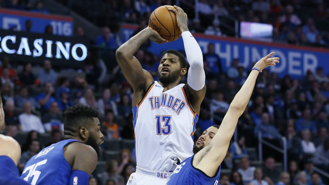 Oklahoma-City-Thunder-forward-Paul-George-(13)-shoots-between-Los-Angeles-Clippers-center-Willie-Reed,-left,-and-guard-Austin-Rivers,-right,-in-the-third-quarter-of-an-NBA-basketball-game-in-Oklahoma-City,-Friday,-Nov.-10,-2017.-Oklahoma-City-won-120-111.-(Sue-Ogrocki/AP)