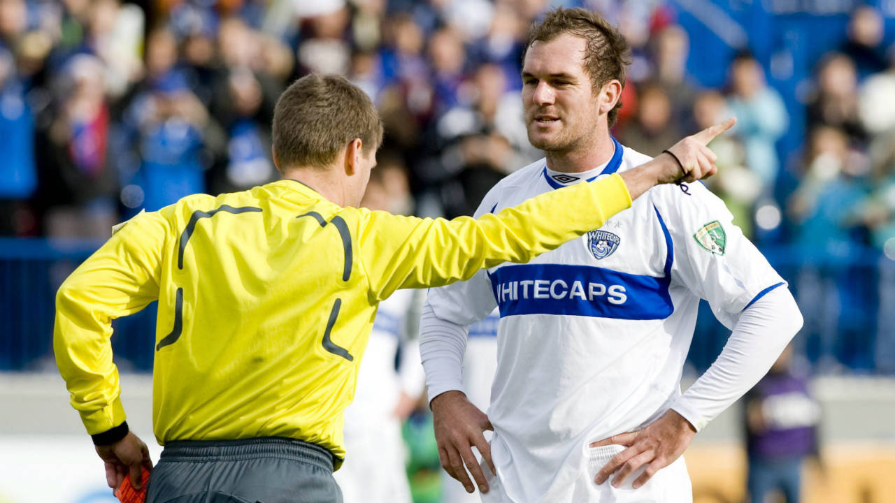 Vancouver-Whitecaps'-Shaun-Pejic,-right,-is-sent-off-by-referee-Dave-Gantar-during-the-first-half-of-the-USL-First-Division-championship-final-against-the-Montreal-Impact-in-Montreal,-Saturday,-October-17,-2009.-(Graham-Hughes/CP)