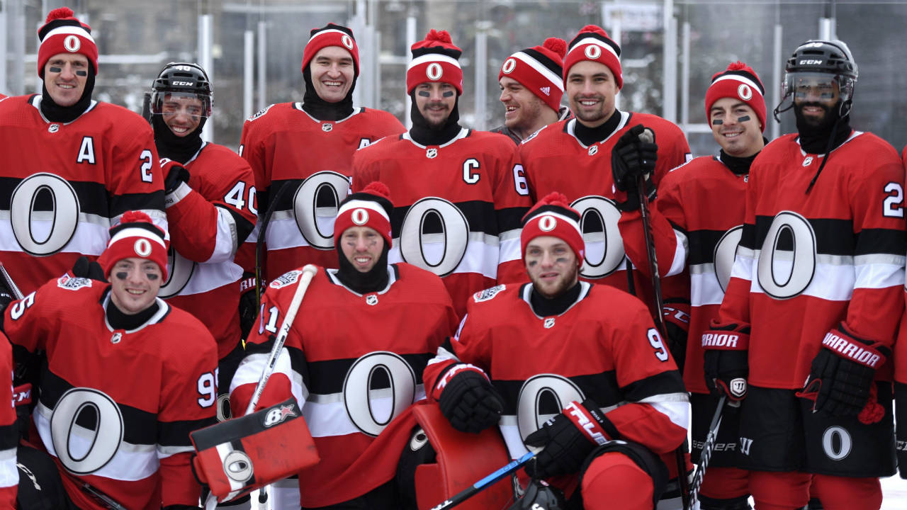 The-Ottawa-Senators,-including-captain-Erik-Karlsson,-pose-for-a-team-photo-on-the-Canada-150-Rink-on-Parliament-Hill,-ahead-of-the-NHL-100-Classic-in-Ottawa-on-Friday,-Dec.-15,-2017.-(Justin-Tang/CP)