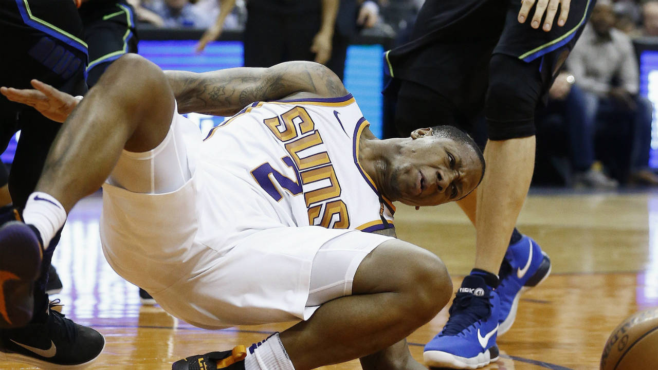 Phoenix-Suns-guard-Isaiah-Canaan-injures-his-foot,-landing-awkwardly,-after-being-fouled-by-the-Dallas-Mavericks-during-the-first-half-of-an-NBA-basketball-game-Wednesday,-Jan.-31,-2018,-in-Phoenix.-(Ross-D.-Franklin/AP)
