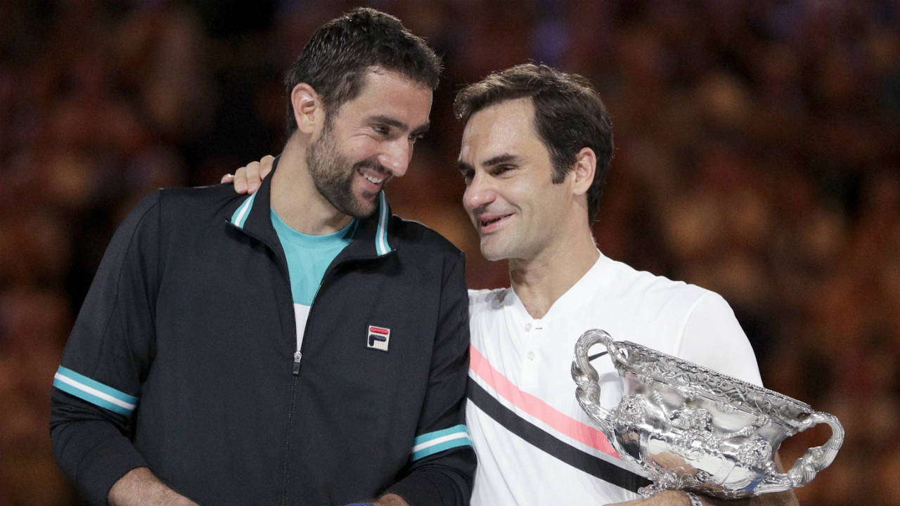 Switzerland's-Roger-Federer,-right,-holds-his-winner's-trophy-while-talking-with-Croatia's-Marin-Cilic-following-the-men's-singles-final-at-the-Australian-Open-tennis-championships-in-Melbourne,-Australia,-Sunday,-Jan.-28,-2018.-(Dita-Alangkara/AP)