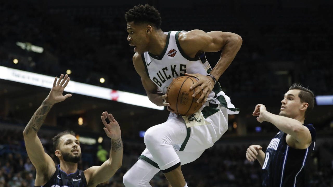 Milwaukee-Bucks'-Giannis-Antetokounmpo-rebounds-over-Orlando-Magic's-Evan-Fournier-(10)-and-Mario-Hezonja-(8)-during-the-second-half-of-an-NBA-basketball-game-Wednesday,-Jan.-10,-2018,-in-Milwaukee.-(Morry-Gash/AP)