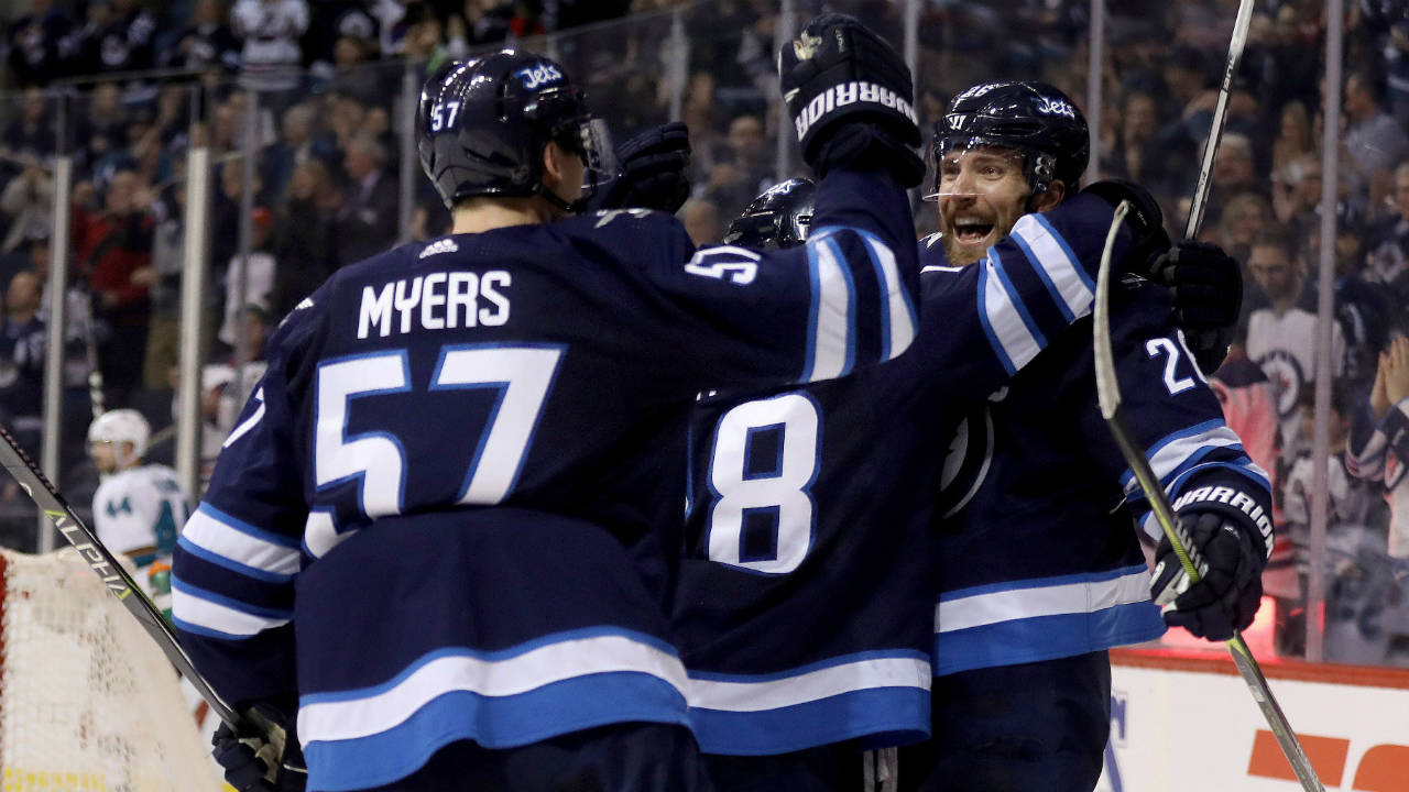 Winnipeg-Jets'-Tyler-Myers-(57),-Mathieu-Perreault-(85)-and-Blake-Wheeler-(26)-celebrate-after-Perreault-scored-against-the-San-Jose-Sharks-during-second-period-NHL-hockey-action-in-Winnipeg,-Sunday,-January-7,-2018.-(Trevor-Hagan/CP)