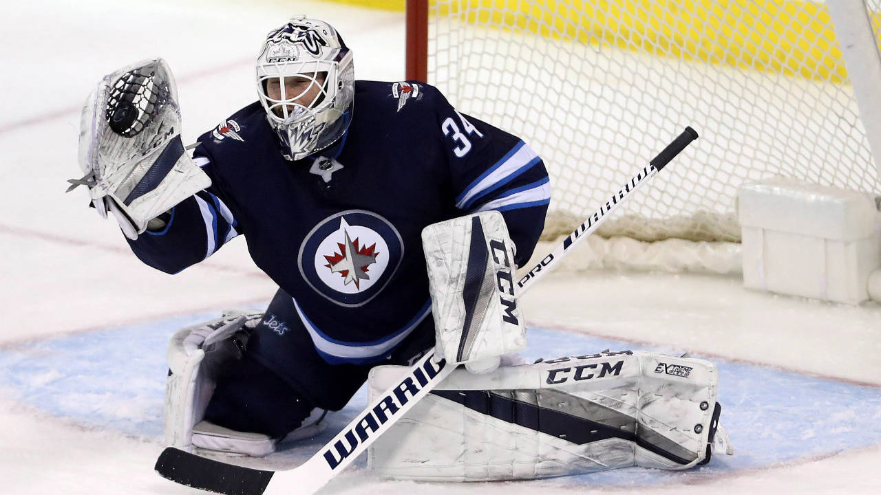 Winnipeg-Jets'-goaltender-Michael-Hutchinson-(34)-makes-a-glove-save-against-the-Tampa-Bay-Lightning-during-third-period-NHL-hockey-action-in-Winnipeg,-Tuesday,-January-30,-2018.-(Trevor-Hagan/CP)