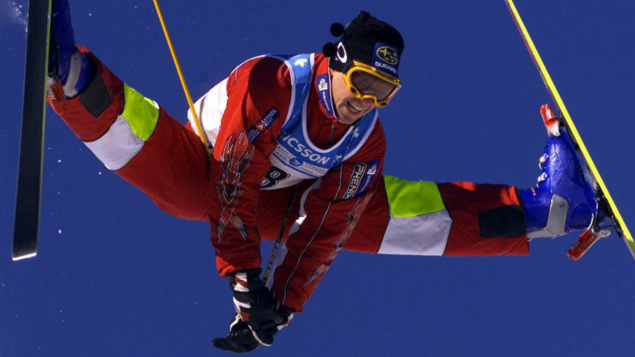 Jean-Luc-Brassard-of-Grande-Ile,-Que.-does-his-famous-Cossack-jump-in-the-men's-moguls-event-at-the-World-Cup-Freestyle-competition-Saturday,-Jan.-15,-2000-in-Mont-Tremblant,-Que.-Even-the-former-king-of-the-moguls-Jean-Luc-Brassard-can't-believe-what-Mikael-Kingsbury-has-accomplished-in-the-past-year.-(Paul-Chiasson/CP)