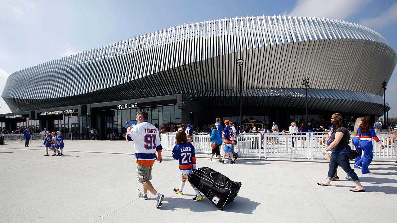 Hockey-fans-make-their-way-toward-the-entrances-of-the-renovated-Nassau-Veterans-Memorial-Coliseum-before-a-preseason-NHL-hockey-game-between-the-New-York-Islanders-and-the-Philadelphia-Flyers-in-Uniondale,-N.Y.,-Sunday,-Sept.-17,-2017.-(Kathy-Willens/AP)