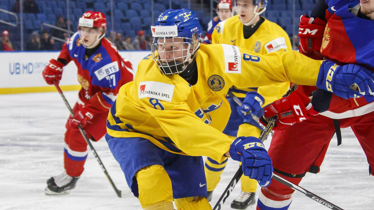 Sweden's-Rasmus-Dahlin-battles-with-Russia's-Dmitri-Sokolov,-right-during-first-period-IIHF-World-Junior-Championship-preliminary-hockey-action-in-Buffalo,-N.Y.,-Sunday,-December-31,-2017.-(Mark-Blinch/CP)