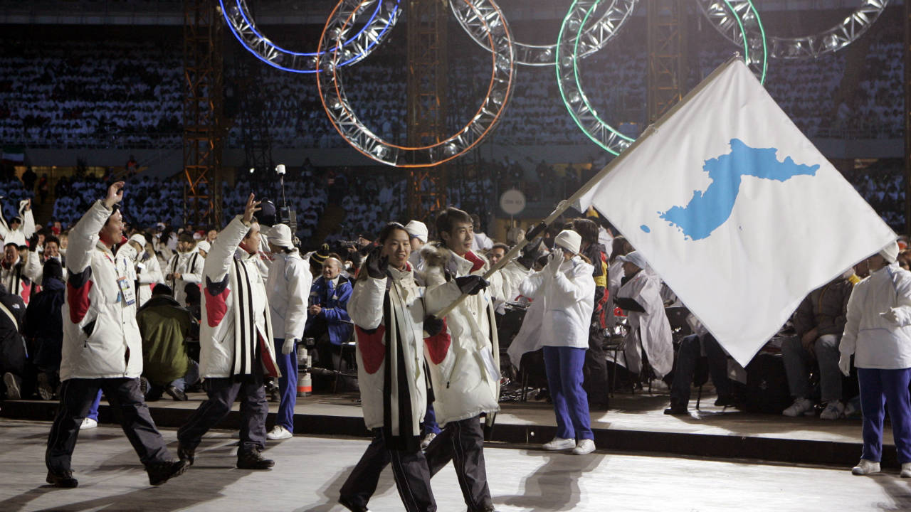In-this-Feb.-10,-2006,-file-photo,-Korea-flag-bearer's-Bora-Lee-and-Jong-In-Lee,-carrying-a-unification-flag-lead-their-teams-into-the-stadium-during-the-2006-Winter-Olympics-opening-ceremony-in-Turin,-Italy.-North-Korea-plans-to-send-a-spotlight-stealing-delegation-to-next-month‚Äôs-Winter-Olympics-in-the-South-Korean-county-of-Pyeongchang.-(Amy-Sancetta,-File/AP)