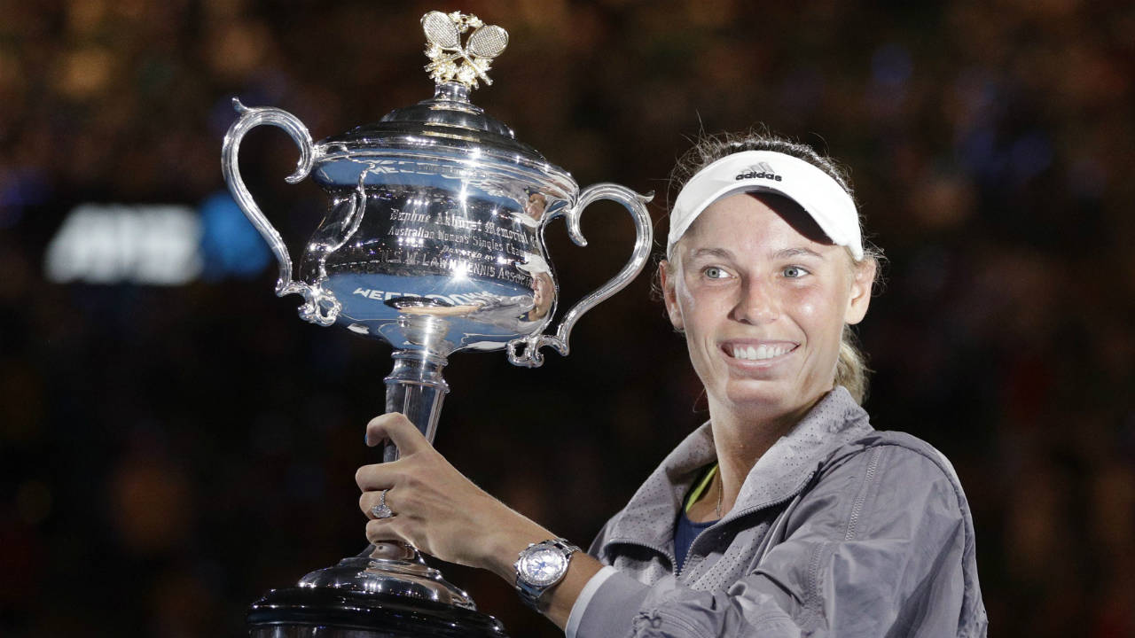 Denmark's-Caroline-Wozniacki-holds-her-trophy-after-defeating-Romania's-Simona-Halep-in-the-women's-singles-final-at-the-Australian-Open-tennis-championships-in-Melbourne,-Australia,-Saturday,-Jan.-27,-2018.-(Dita-Alangkara/AP)