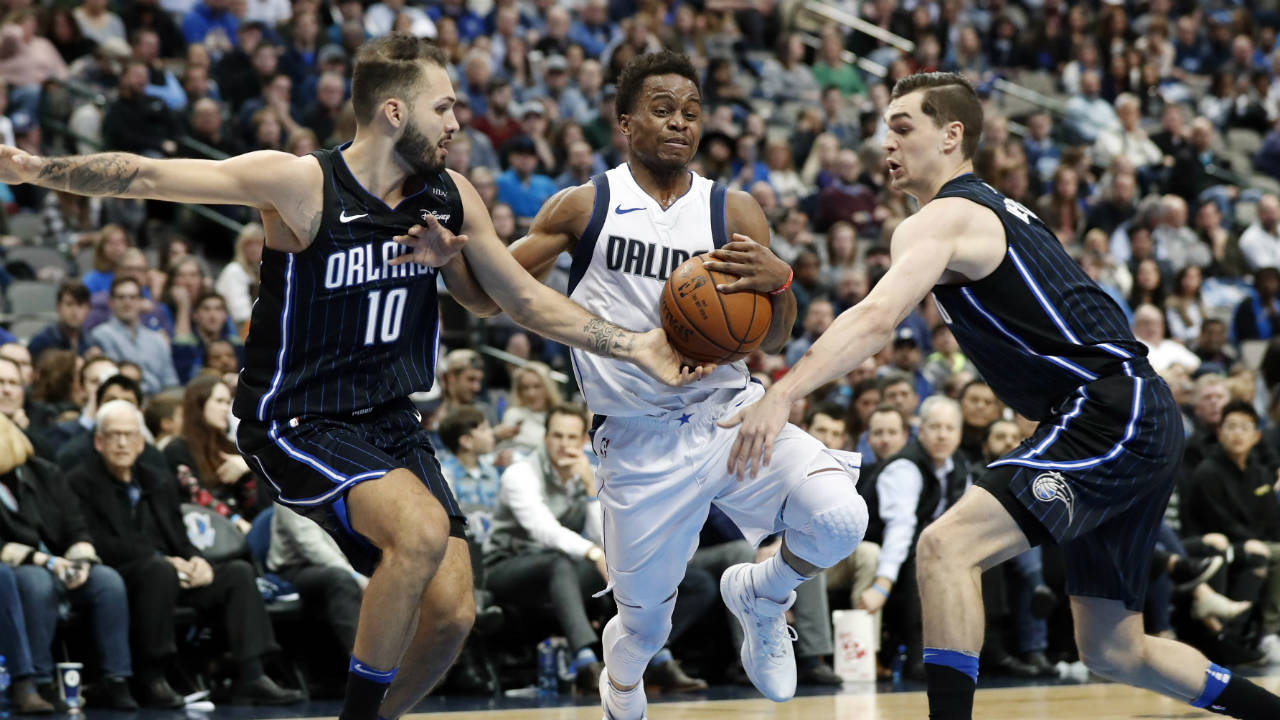 Orlando-Magic-forward-Evan-Fournier-(10)-of-France-and-guard-Mario-Hezonja,-right,-of-Croatia-defend-as-Dallas-Mavericks'-Yogi-Ferrell-(11)-drives-to-the-basket-in-the-second-half-of-an-NBA-basketball-game,-Tuesday,-Jan.-9,-2018,-in-Dallas-.-(Tony-Gutierrez/AP)