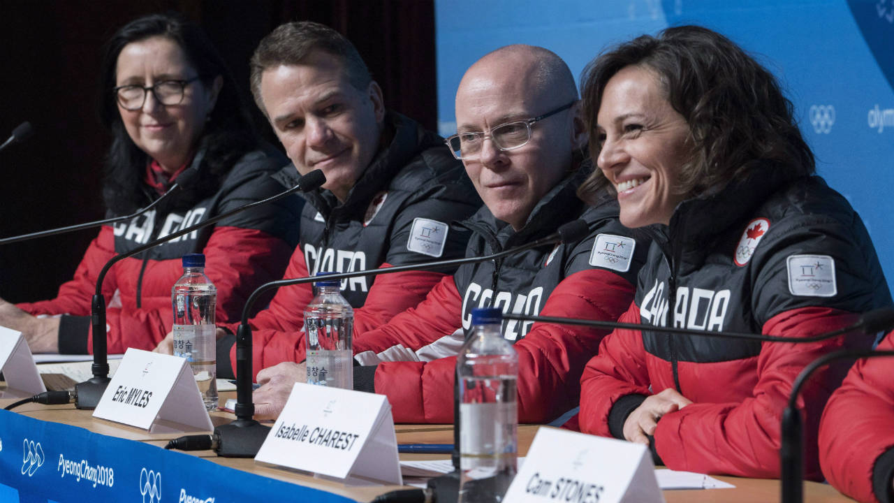 COC-president-Tricia-Smith,-CEO-Chris-Overholt,-executive-director-Eric-Myles,-left-to-right,-listen-to-Chef-de-Mission-Isabelle-Charest.-(Paul-Chiasson/CP)